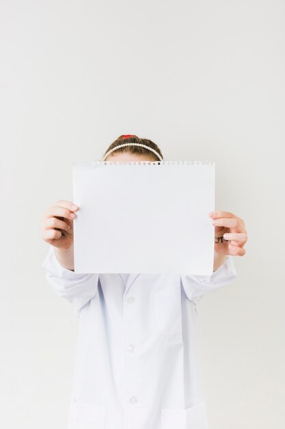 Girl holding blank paper sheet 