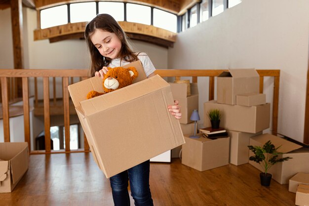 Girl holding box with toy medium shot