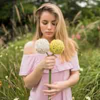 Free photo girl holding bright flowers in park