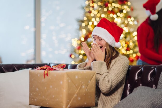 Girl holding a Christmas present in Christmas.