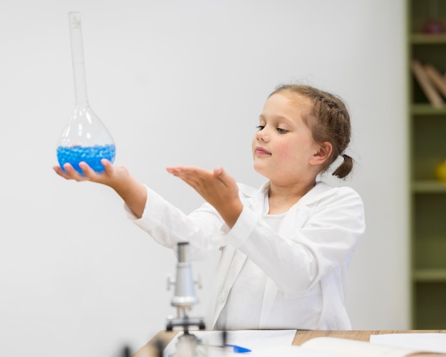 Girl holding science tube