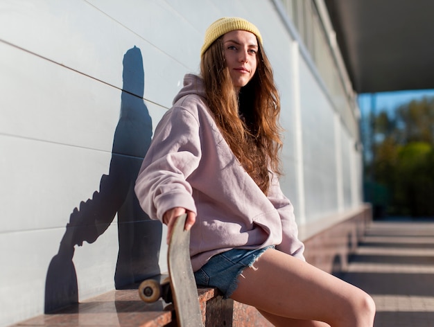 Free Photo girl holding skateboard medium shot