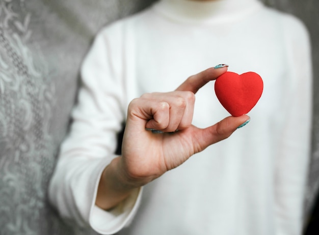 Free Photo girl holding a small lovely heart (tiny things for a valentine's day)