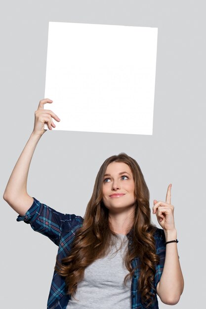 Girl holding white billboard