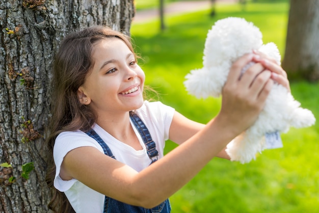 Free Photo girl holding with a stuffed toy