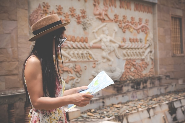 Free photo girl holds a tourist map in the old town.