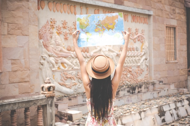 Free photo girl holds a tourist map in the old town.