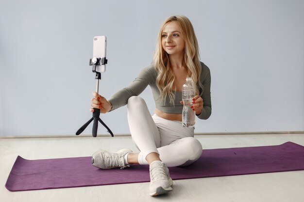 Girl at home. Woman make yoga. Lady shoot a video blog.