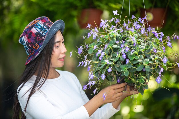 The girl is admiring the flowers in the garden.