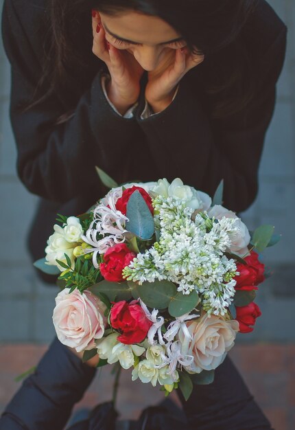 Girl is suprised by man offering a flower bouquet