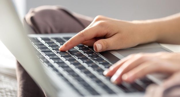 Free Photo the girl is typing on the laptop keyboard girls hands on the keyboard