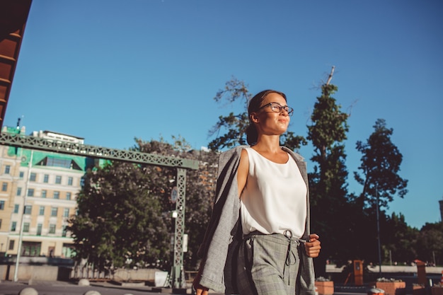 the girl is walking around the city