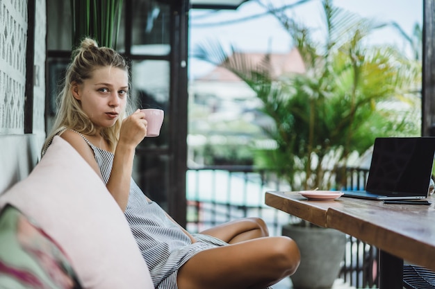 Free photo girl is working in a cafe. concept of freelancing, coffee and laptop.