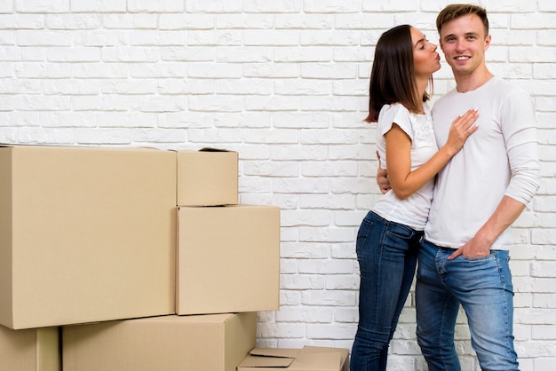 Girl kissing her boyfriend while smiling