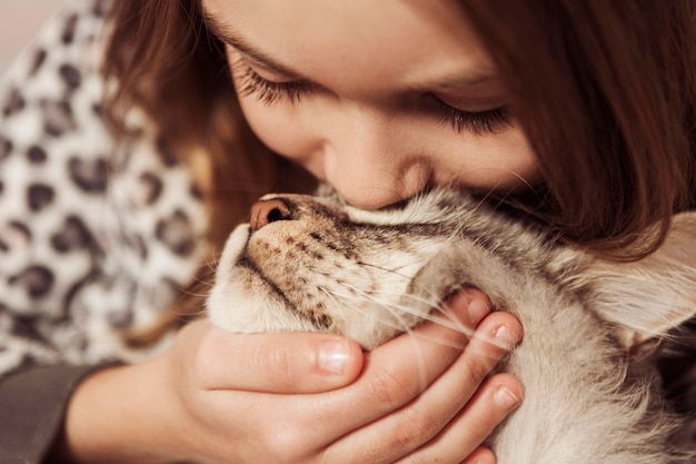 Free photo girl kissing her cat