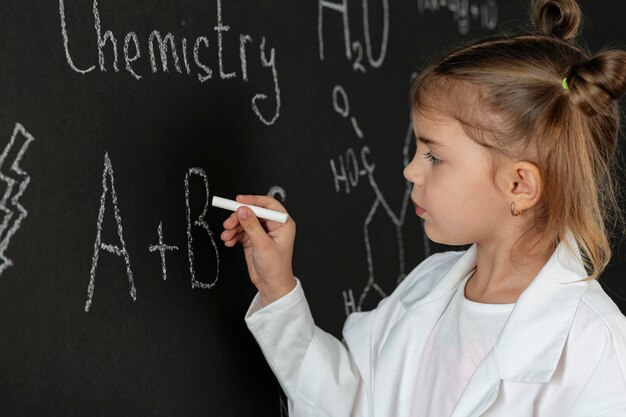 Girl in laboratory with coat writing