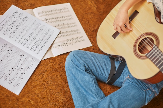 Free Photo girl learning how to play guitar at home