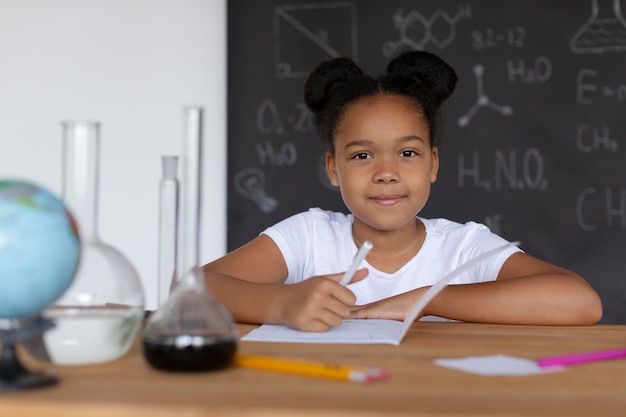 Girl learning more about chemistry in class