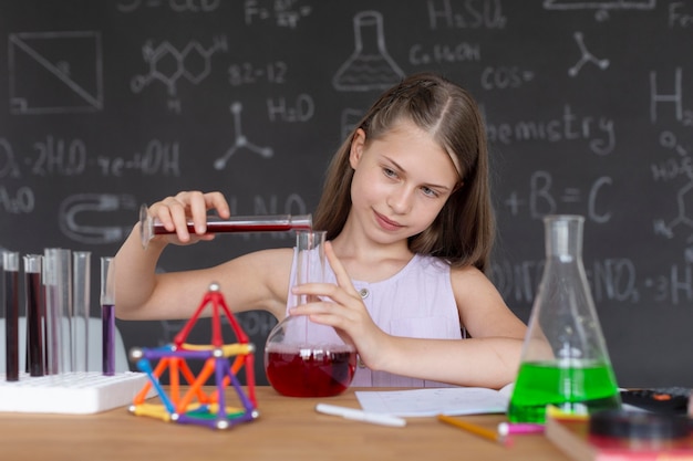 Girl learning more about chemistry in class