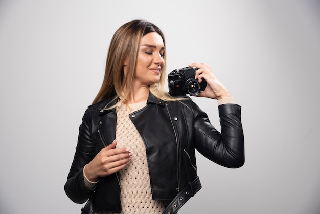 Girl in leather jacket taking her photos in elegant and positive positions.