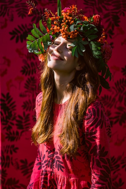 Free photo girl in a linen dress. with a wreath of flowers on her head.