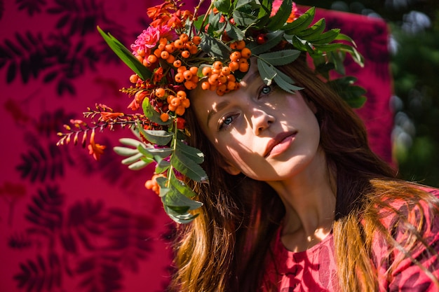 Free photo girl in a linen dress. with a wreath of flowers on her head.