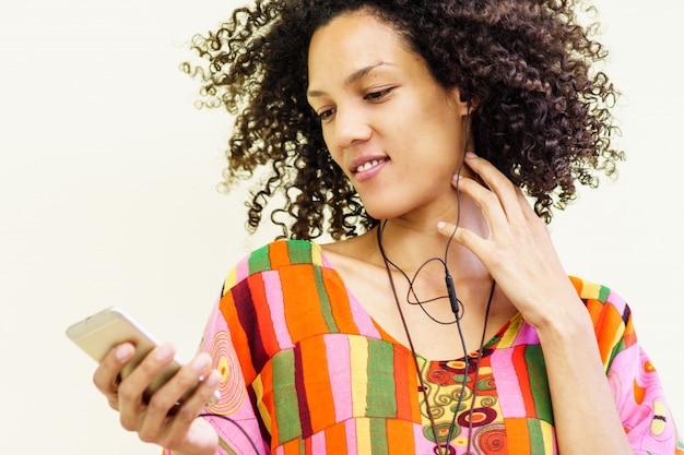 Girl listening to music with her cell phone and using headphones