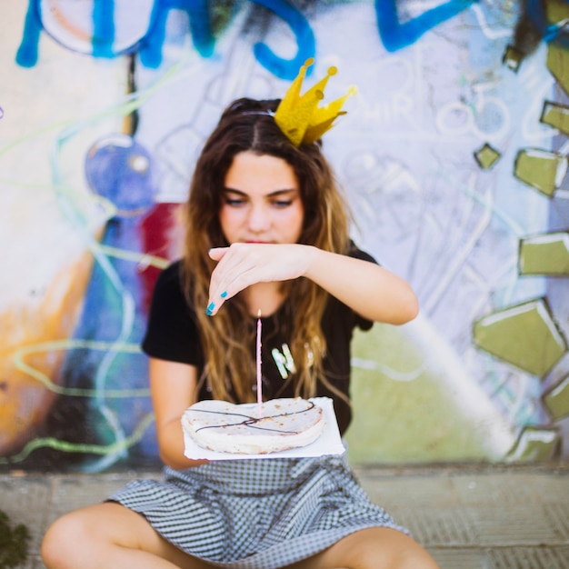 Free photo girl looking at birthday pastry