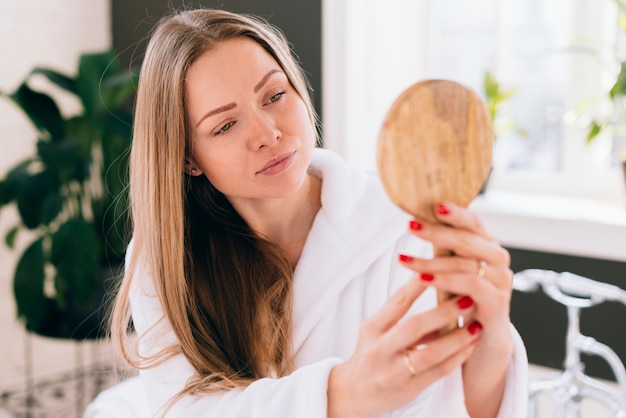 Girl looking herself at a mirror