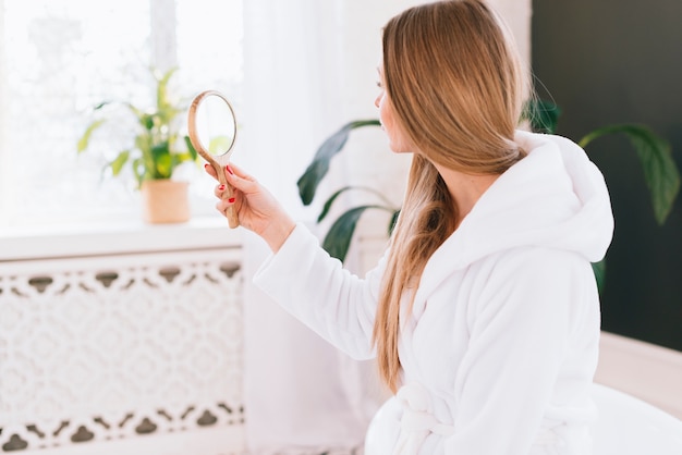 Girl looking herself at a mirror