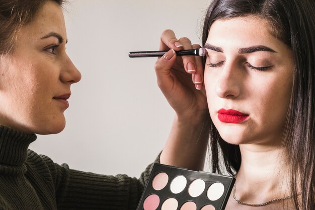 Girl making up her eyes