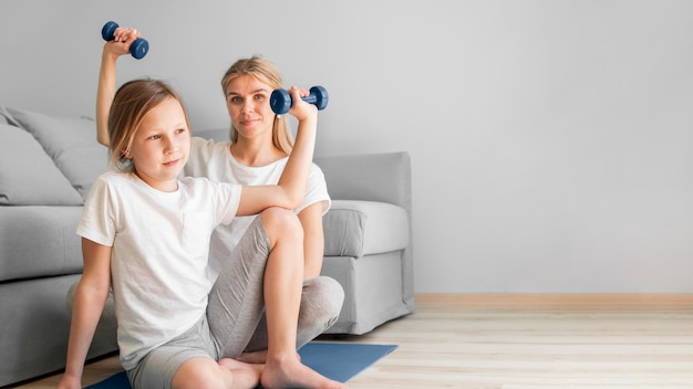 Free Photo girl and mom exercise with weights