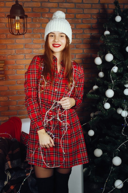 Free photo girl near christmas tree