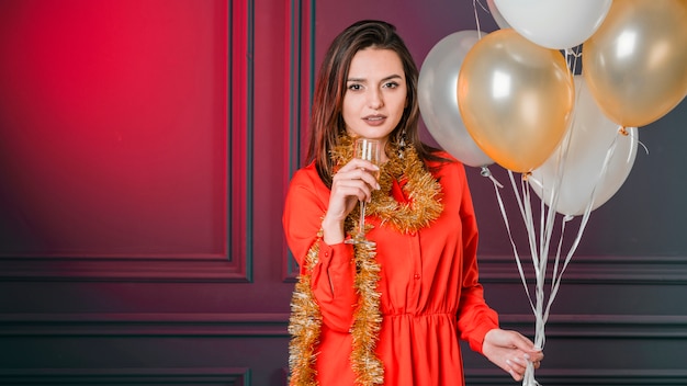 Girl offering champagne with balloons