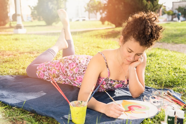 Girl painting on canvas