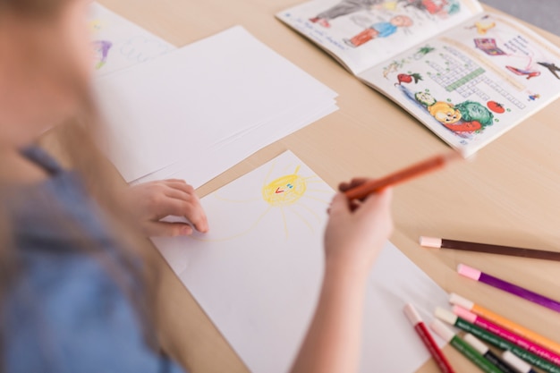 Girl painting on table