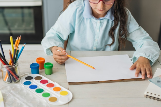 Free Photo girl painting with watercolor at home