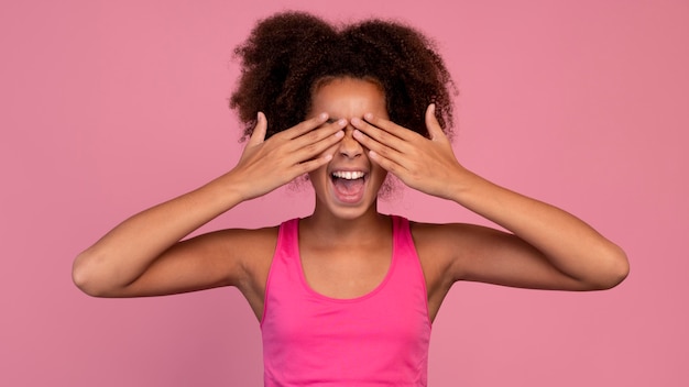 Girl in pink covering her eyes