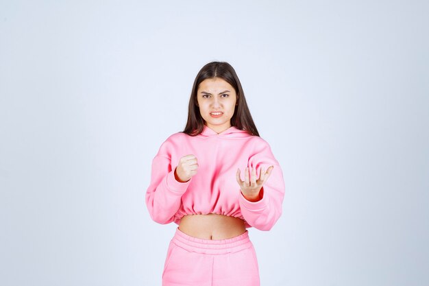 Girl in pink pajamas looks like a fighter and agressive