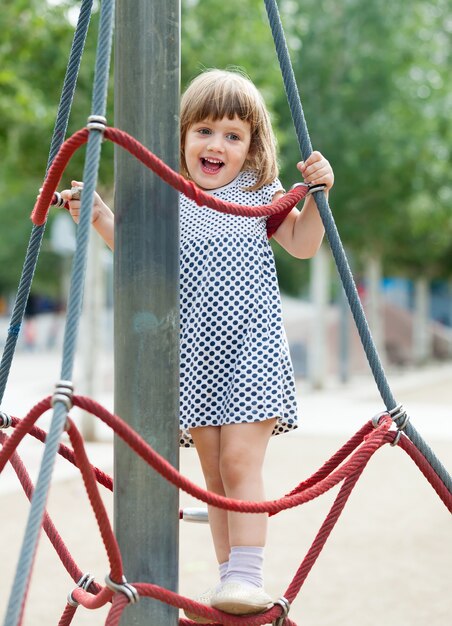  girl at playground area in  summer  