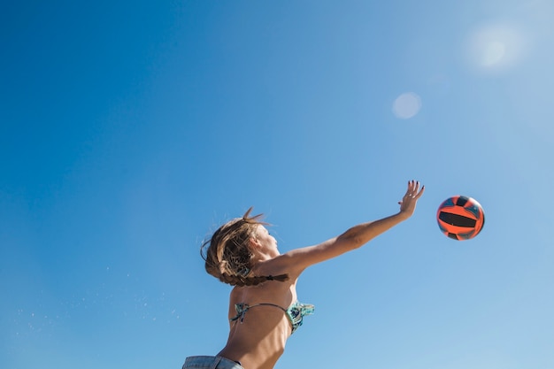 Free Photo girl playing beach volley view from below