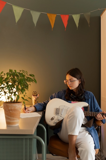 Free Photo girl playing the guitar front view