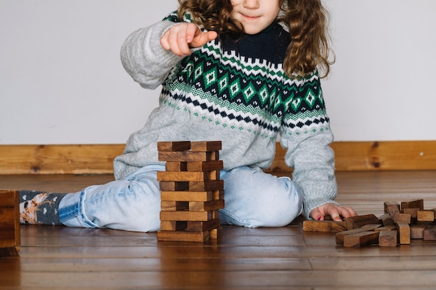 Free Photo girl playing jenga at home