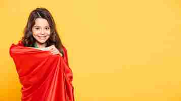 Free photo girl playing in superhero costume