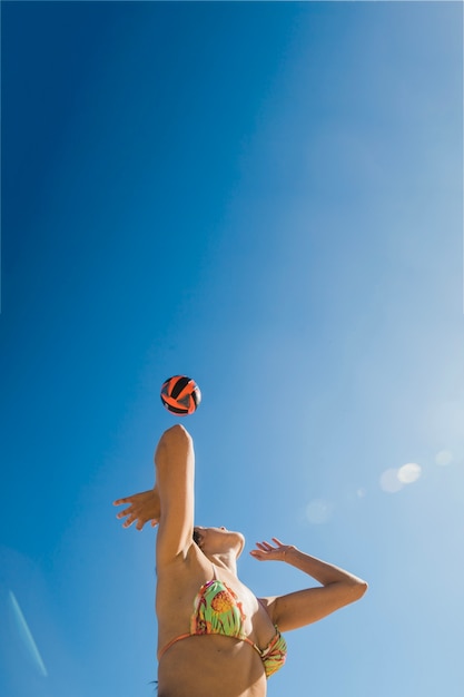 Girl playing volleyball on a sunny day