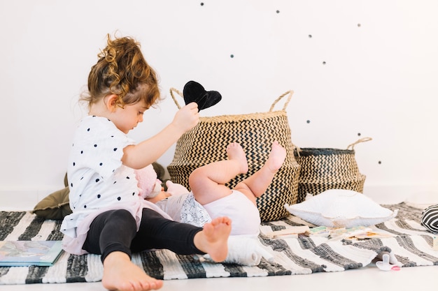 Girl playing with baby