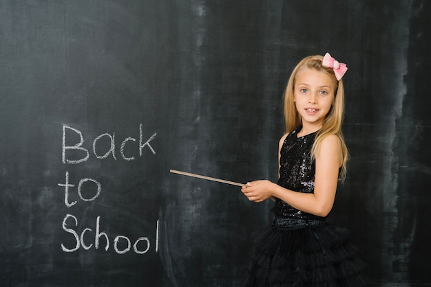 Girl pointing on blackboard