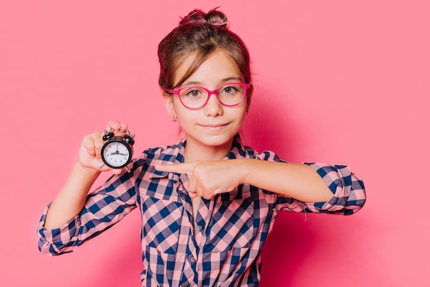 Girl pointing at clock