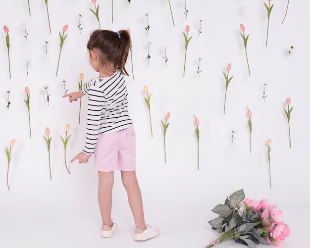 Girl pointing at flowers