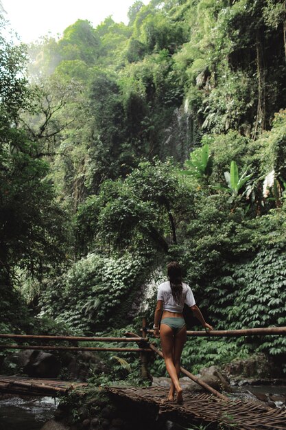 Girl posing against the backdrop of a waterfall